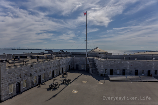 The British flag flies over the courtyard of Fort Henry.  Cannons point outwards towards the St Lawrence River.