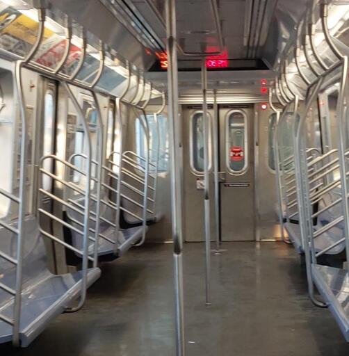 New York Subway S train showing the current time on its informational display